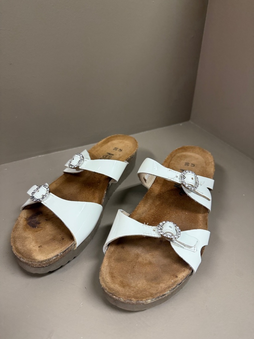 NAOT White Patent Sandals with Circular Rhinestone Buckles & Cork Footbed